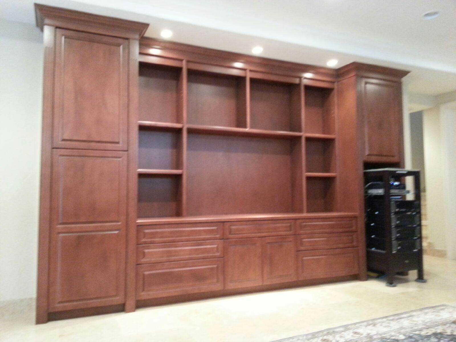Custom entertainment cabinetry wall in rich wood finish